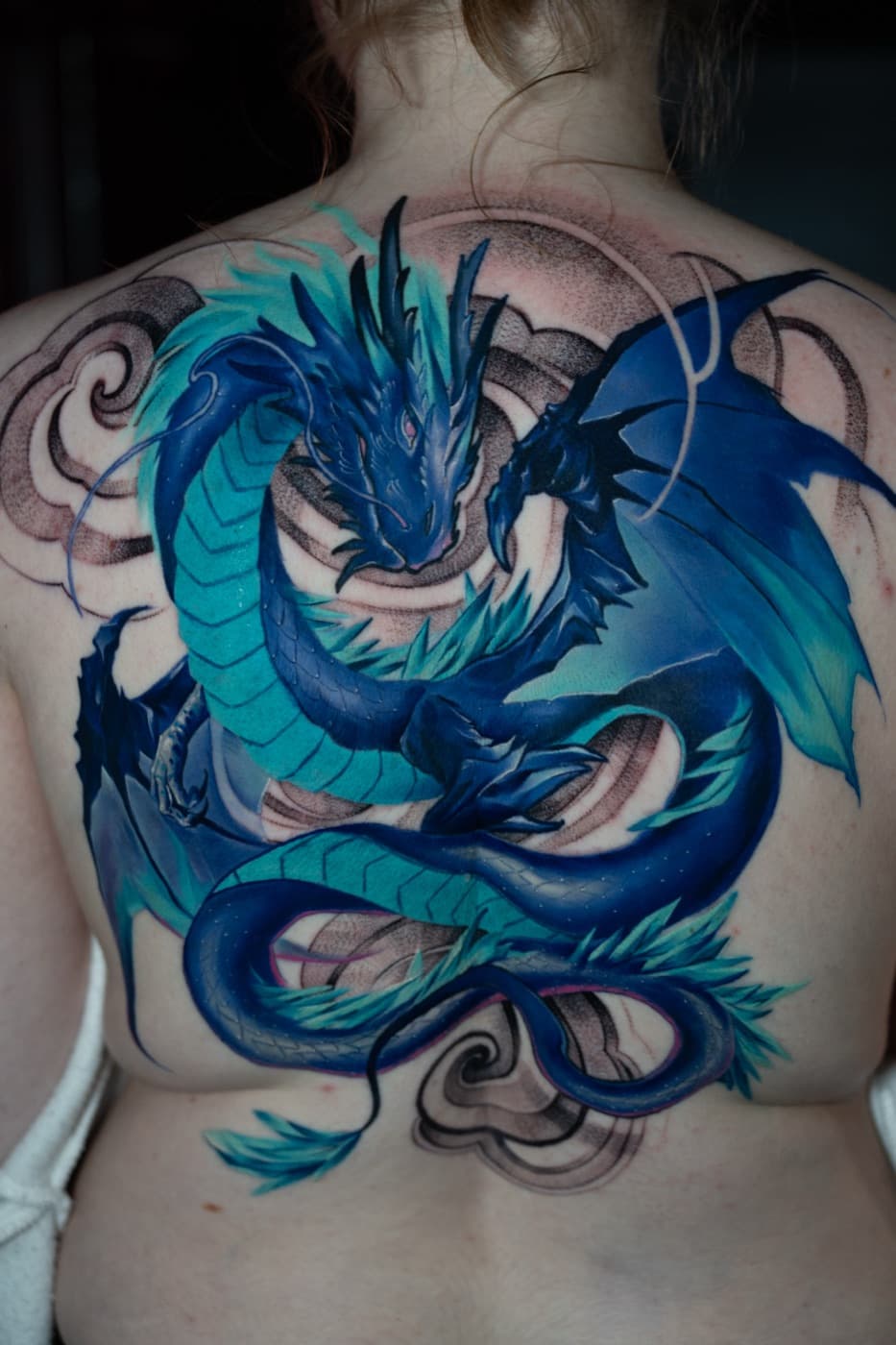 Blue dragon back piece tattoo in colour illustration style