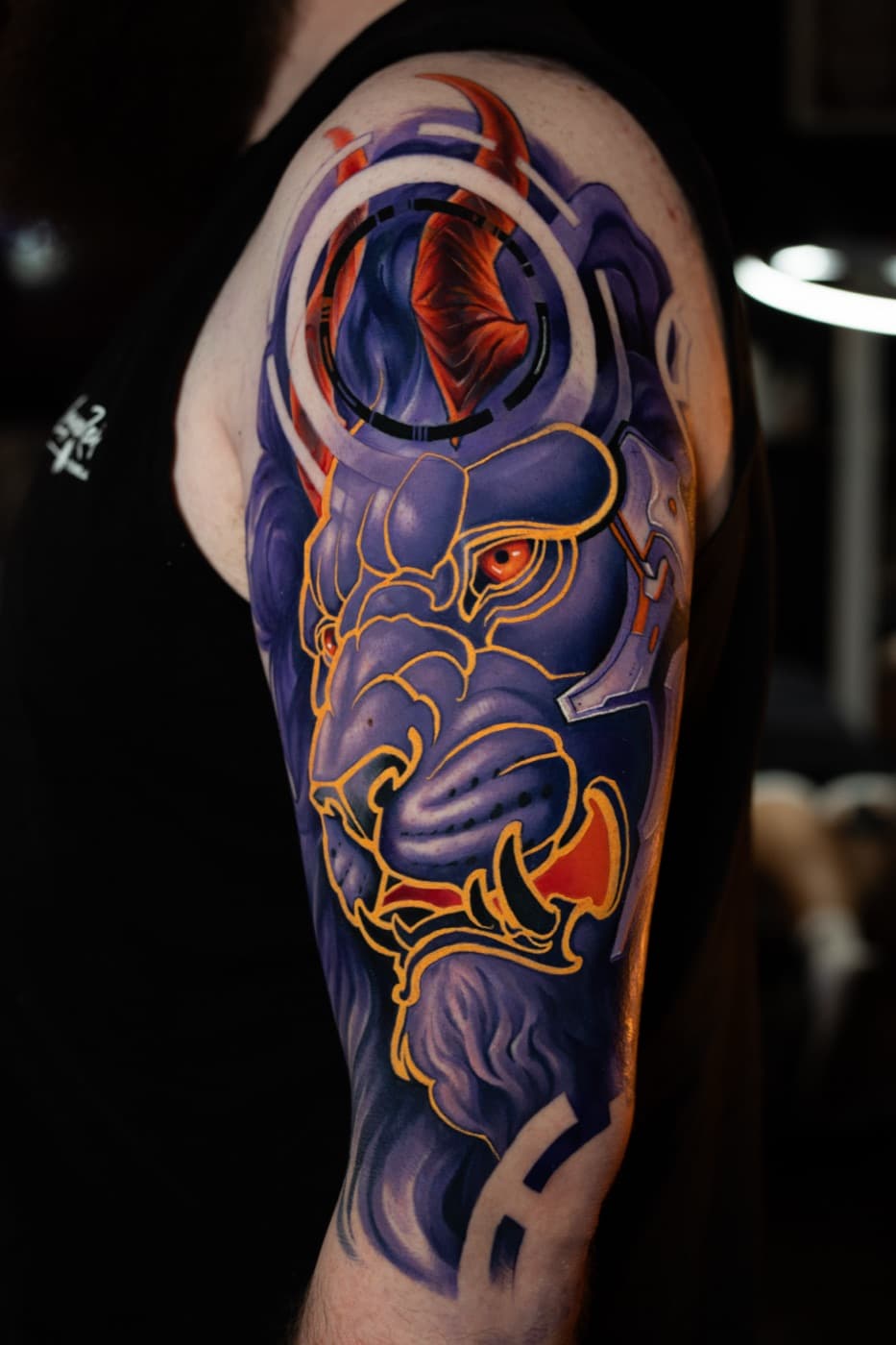Purple lion head tattoo with cyberpunk-style linework