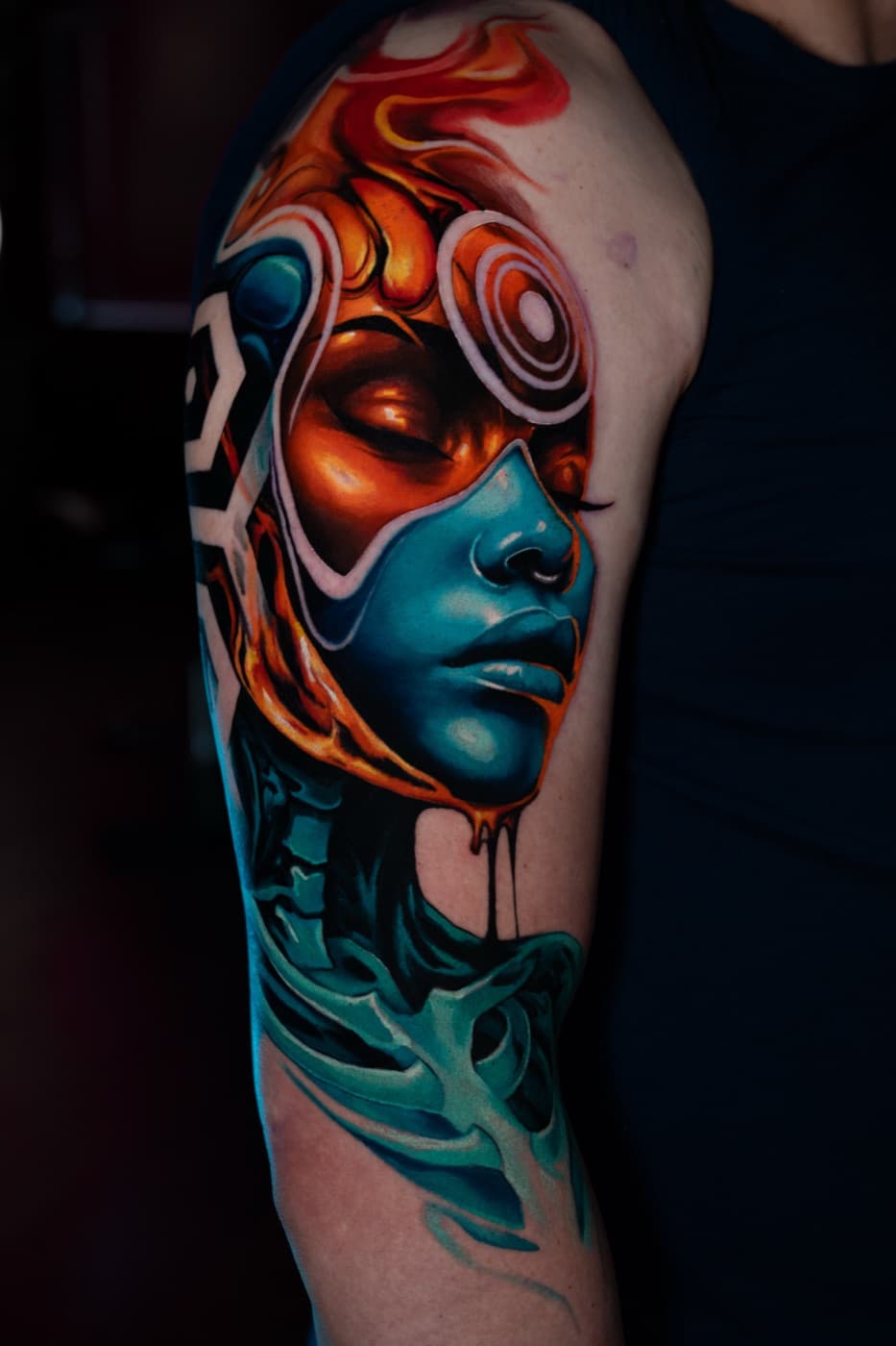 Orange and teal mask-style portrait tattoo