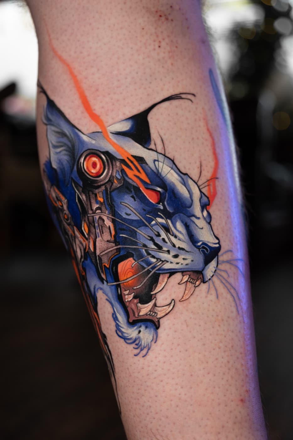 Cyberpunk lynx tattoo with glowing red eye detail